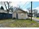 Tan house with a security door, and a small yard at 1338 W 25Th St, Indianapolis, IN 46208