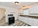 White kitchen with wood-look floors and appliances at 1338 W 25Th St, Indianapolis, IN 46208