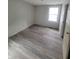 Bedroom with new wood-look flooring and gray walls at 1445 W 34Th St, Indianapolis, IN 46208
