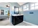 Modern bathroom with dark vanity, white countertop, and a mirror at 16845 Downstream Dr, Westfield, IN 46062