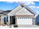 Gray siding, stone accents, and a two-car garage characterize this charming home's exterior at 16970 Adler Ln, Noblesville, IN 46060