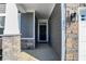 Inviting entryway with stone pillars and a dark brown front door at 16970 Adler Ln, Noblesville, IN 46060