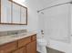 Bathroom with wood vanity, large mirror, and a shower/tub combo at 2022 Calvert Cir, Greenwood, IN 46143