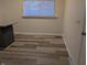 Simple dining area with wood-look vinyl flooring and a window at 2307 Bramble Way, Anderson, IN 46011