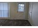 Bright entryway with carpeted floors, a window, and a white door at 2307 Bramble Way, Anderson, IN 46011