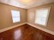 Simple bedroom with hardwood floors and two windows with blinds at 2817 N New Jersey St, Indianapolis, IN 46205