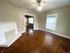 Living room with hardwood floors, a fireplace, and a view to another room at 2817 N New Jersey St, Indianapolis, IN 46205