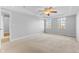 Well-lit bedroom with neutral walls, carpet, and access to hallway at 3 Lakewood Dr, Trafalgar, IN 46181