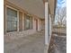 Covered front porch with brick facade and red door at 3 Lakewood Dr, Trafalgar, IN 46181