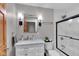 Bathroom with a marble countertop, black fixtures, and white tile at 304 N College Ave # Apt A, Indianapolis, IN 46202