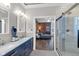 Stylish bathroom with a glass shower door and double sinks, transitioning into a bedroom at 304 N College Ave # Apt A, Indianapolis, IN 46202