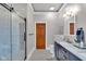 Elegant bathroom features a glass-enclosed shower, hexagon tile floor, and navy vanity with marble countertop at 304 N College Ave # Apt A, Indianapolis, IN 46202