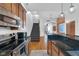 Open concept kitchen with island, stainless appliances and adjacent staircase at 304 N College Ave # Apt A, Indianapolis, IN 46202