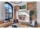 Comfortable living room with exposed brick wall, white fireplace, mounted TV, and modern decor at 304 N College Ave # Apt A, Indianapolis, IN 46202