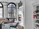 Bright, stylish living room with large window, white fireplace, mounted TV, and comfortable seating area at 304 N College Ave # Apt A, Indianapolis, IN 46202