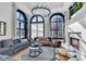 Bright living room featuring large arched windows, hardwood floors, and a modern fireplace at 304 N College Ave # Apt A, Indianapolis, IN 46202