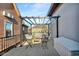 Outdoor patio area with string lights, chairs, and a wooden deck at 304 N College Ave # Apt A, Indianapolis, IN 46202