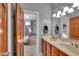 Bathroom leading to bedroom features a double vanity with large mirror and wood-toned cabinets at 304 N College Ave # Apt B, Indianapolis, IN 46202