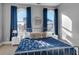 Bedroom featuring two arched windows with blue drapes and side tables with lamps at 304 N College Ave # Apt B, Indianapolis, IN 46202