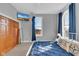 Bedroom with gray walls featuring blue drapes, side table with lamp, and mounted TV at 304 N College Ave # Apt B, Indianapolis, IN 46202