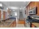 Open concept kitchen with granite countertops, stainless appliances, and seamless flow into dining and living spaces at 304 N College Ave # Apt B, Indianapolis, IN 46202