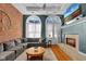 Comfortable living room features a gas fireplace, exposed brick wall and multiple windows for natural light at 304 N College Ave # Apt B, Indianapolis, IN 46202