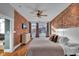 Spacious main bedroom with exposed brick wall, ceiling fan, and large windows for lots of natural light at 304 N College Ave # Apt B, Indianapolis, IN 46202