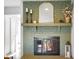 Green brick fireplace with gold framed mirror and mantel at 3699 Lisa Ln, Plainfield, IN 46168