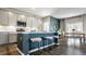 Modern kitchen with light cabinets, blue island, and stainless steel appliances at 4602 White Willow Way, New Palestine, IN 46163