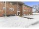 Brick building exterior with entrance, walkway, and snow at 5038 Allisonville Rd # A, Indianapolis, IN 46205