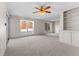 Living room with ceiling fan and large windows at 5038 Allisonville Rd # A, Indianapolis, IN 46205