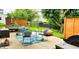 Backyard patio with seating area, shade tree, outdoor rug, and privacy fence at 5340 Thompson Park Blvd, Indianapolis, IN 46237