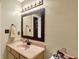 Well-lit bathroom with a vanity, mirror, and neutral color scheme at 5340 Thompson Park Blvd, Indianapolis, IN 46237