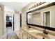 Bathroom with double sinks, vanity, and access to bedroom at 5340 Thompson Park Blvd, Indianapolis, IN 46237
