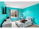 Teal bedroom with twin bed, desk, and window at 5340 Thompson Park Blvd, Indianapolis, IN 46237