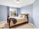Bedroom with double bed, window and blue walls at 5340 Thompson Park Blvd, Indianapolis, IN 46237