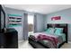 Bright bedroom with a queen bed, large window, and decorative accents at 5340 Thompson Park Blvd, Indianapolis, IN 46237
