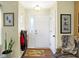 Bright entryway with hardwood floors, coat rack, and a comfortable armchair at 5340 Thompson Park Blvd, Indianapolis, IN 46237