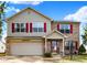 Two-story house with red shutters, brick accents, and a spacious driveway at 5340 Thompson Park Blvd, Indianapolis, IN 46237