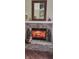 Brick fireplace with a warm inviting fire at 5340 Thompson Park Blvd, Indianapolis, IN 46237