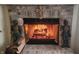 Brick fireplace with a warm inviting fire at 5340 Thompson Park Blvd, Indianapolis, IN 46237