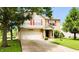 Attractive home featuring a blend of vinyl and brick, with an attached garage and landscaped front yard at 5340 Thompson Park Blvd, Indianapolis, IN 46237