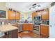 Modern kitchen with stainless steel appliances and wood cabinets at 5340 Thompson Park Blvd, Indianapolis, IN 46237
