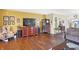 Living room with hardwood floors, a large TV, and lots of natural light at 5340 Thompson Park Blvd, Indianapolis, IN 46237