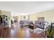 Open living room with hardwood floors, view into kitchen, and comfortable seating at 5340 Thompson Park Blvd, Indianapolis, IN 46237