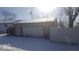 Single car garage with white door and snow on roof at 5473 E 19Th St, Indianapolis, IN 46218