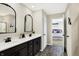 Modern bathroom featuring dual sinks, dark cabinets, matte black fixtures and modern lighting at 5766 Aleppo Ln, Greenwood, IN 46143