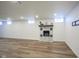 Finished basement with fireplace, wood-look floors, and recessed lighting at 6027 Central Ave, Indianapolis, IN 46220