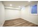 Finished basement room with wood-look floors and recessed lighting at 6027 Central Ave, Indianapolis, IN 46220