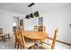 Bright dining room with wood table and chairs, showcasing an elegant light fixture at 611 Dellingham Dr # B, Indianapolis, IN 46260